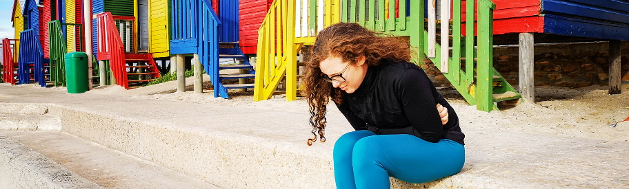 Woman with abdominal pain at the beach