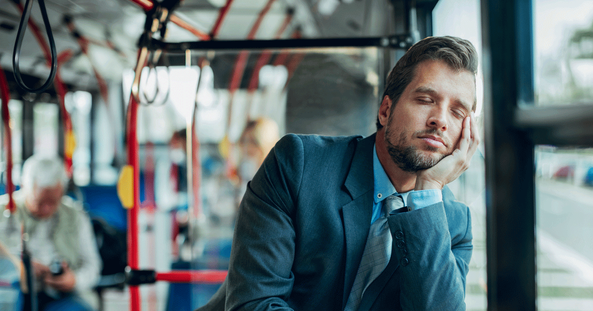 Adult man sitting alone appearing fatigued and mentally drained